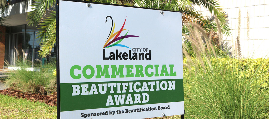 Photo of City of Lakeland Commercial Beautification Award outside GWCF's Lakeland office