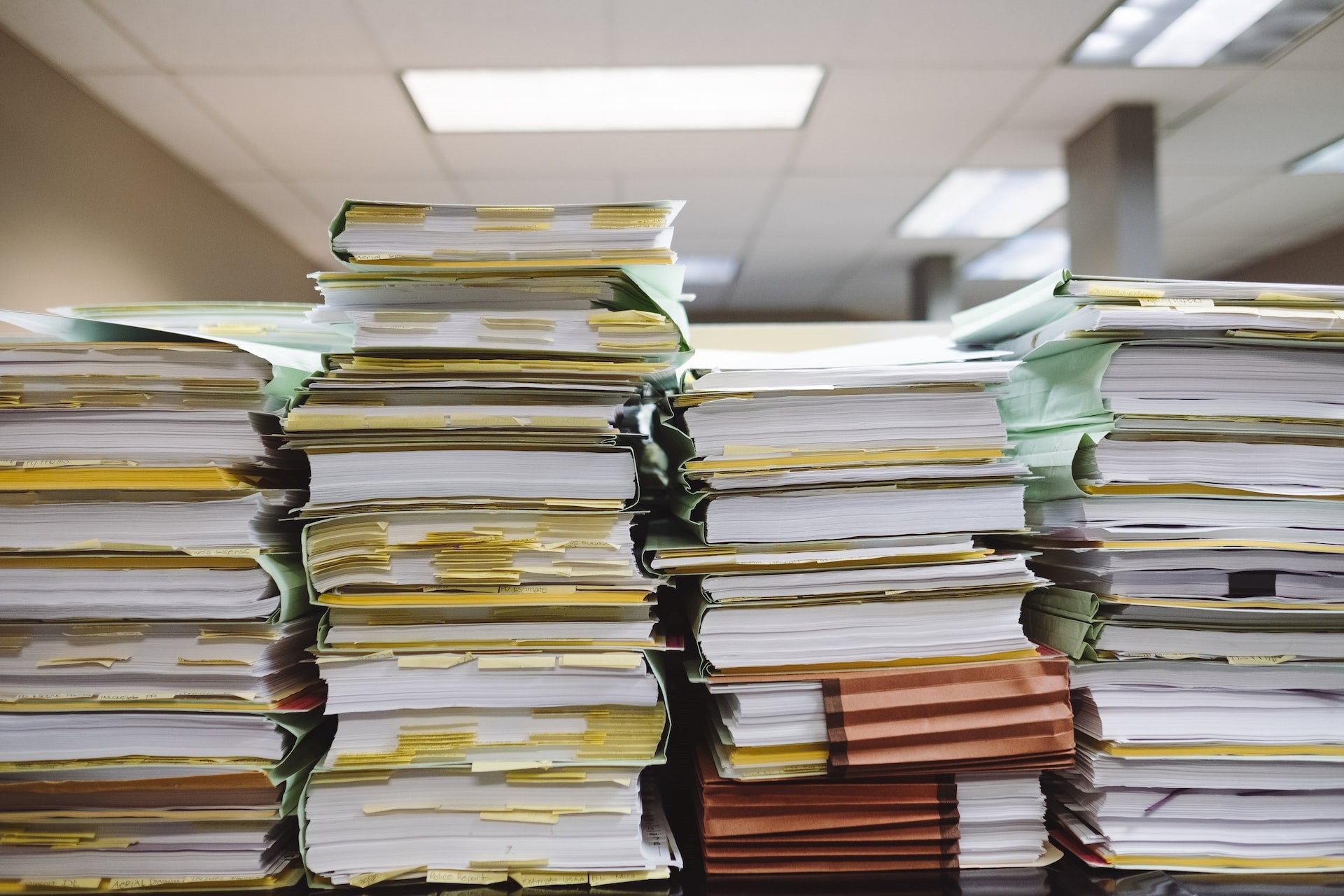 Stacks of paper documents piled up in an office